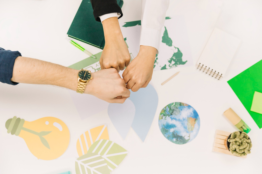 group-businesspeople-fist-bumping-desk